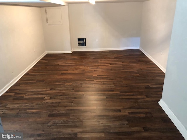 basement with dark wood-style floors and baseboards