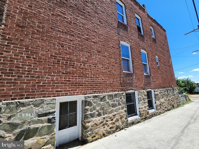 view of property exterior with brick siding