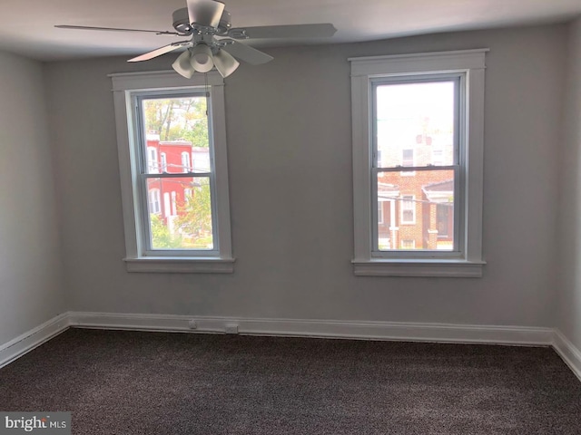 empty room featuring ceiling fan, carpet, and baseboards