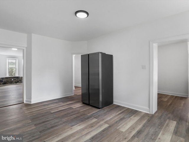 unfurnished room featuring dark wood finished floors and baseboards