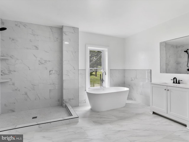 full bath featuring a freestanding tub, a marble finish shower, marble finish floor, and vanity