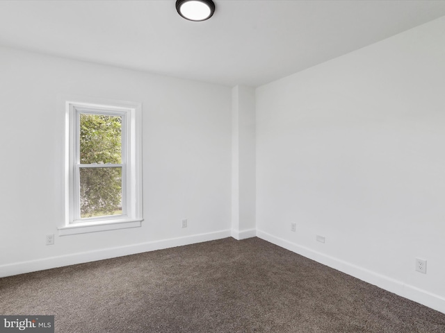 unfurnished room featuring carpet floors and baseboards