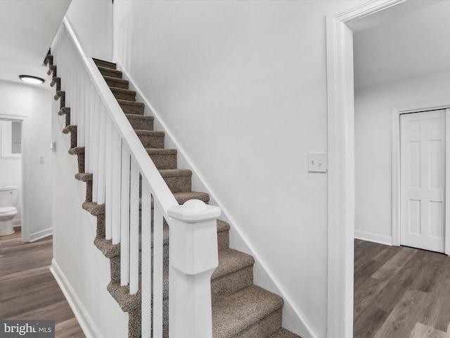 stairs featuring baseboards and wood finished floors