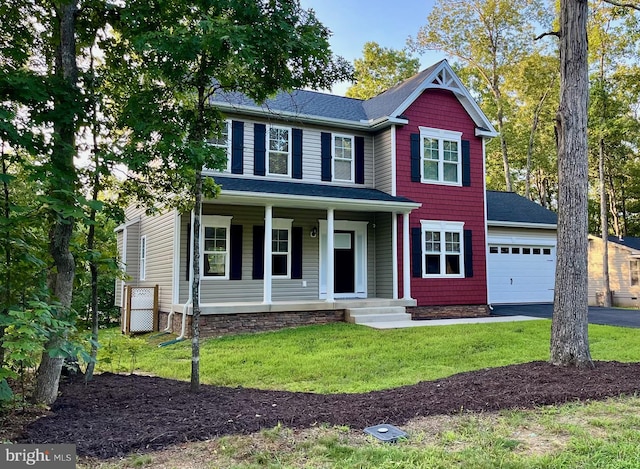 view of front facade featuring a garage, a front lawn, and a porch