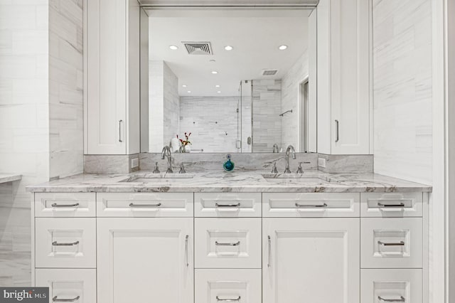 bathroom with vanity, tile walls, and walk in shower