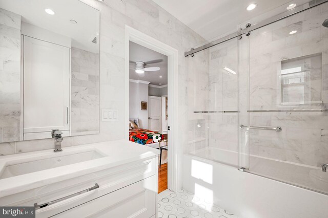 bathroom with tile patterned floors, shower / bath combination with glass door, vanity, ornamental molding, and ceiling fan