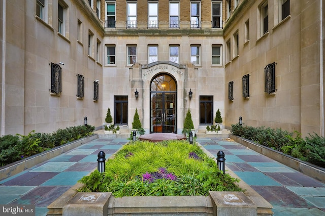 property entrance featuring a patio area and french doors