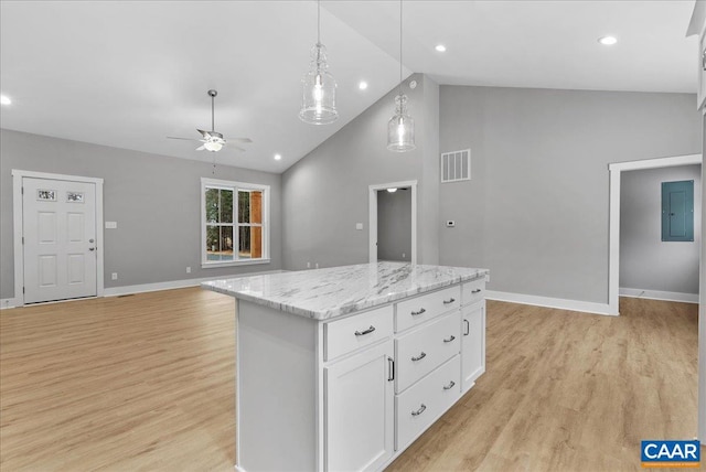 kitchen featuring white cabinets, a kitchen island, decorative light fixtures, light hardwood / wood-style floors, and high vaulted ceiling