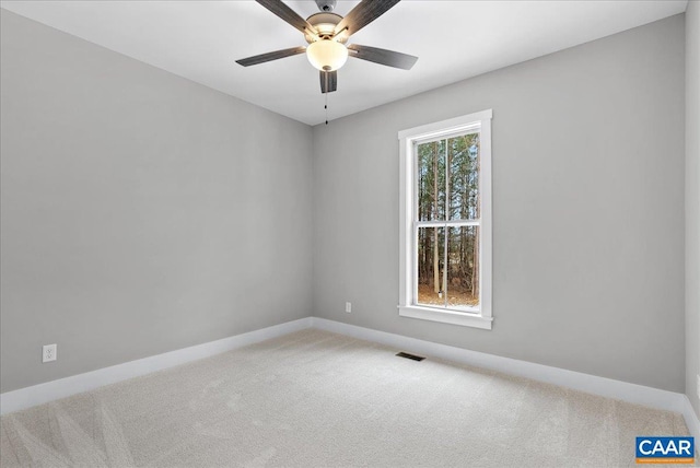 carpeted spare room with ceiling fan