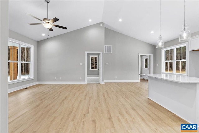 unfurnished living room with ceiling fan, high vaulted ceiling, and light hardwood / wood-style flooring