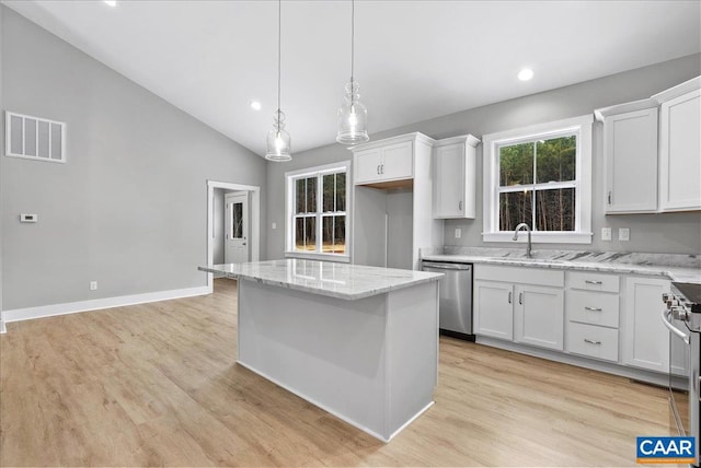 kitchen with white cabinetry, appliances with stainless steel finishes, and a kitchen island