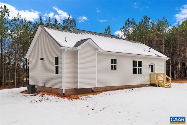 view of snowy exterior featuring cooling unit