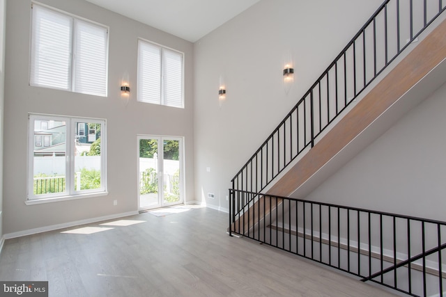 foyer featuring light wood-type flooring and a high ceiling