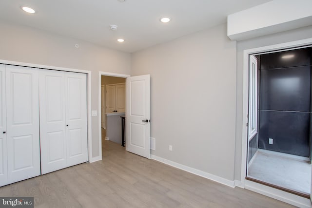 unfurnished bedroom featuring a closet and light hardwood / wood-style flooring