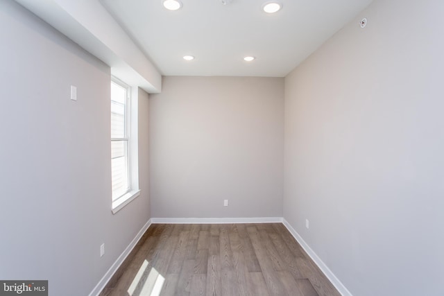 empty room with a healthy amount of sunlight and hardwood / wood-style floors