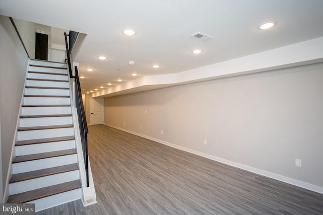 basement with hardwood / wood-style flooring