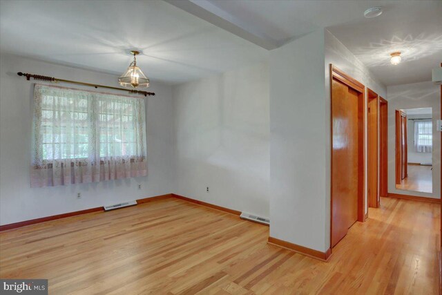 unfurnished room with light hardwood / wood-style floors