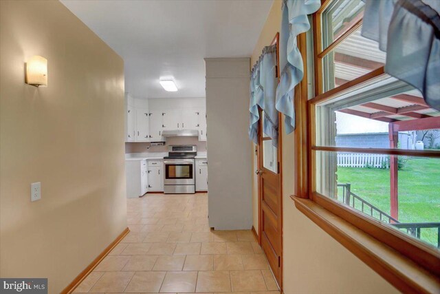 hall featuring light tile patterned floors