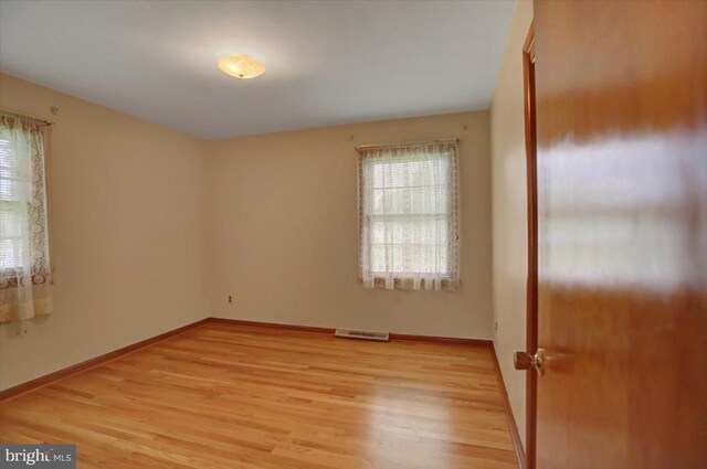 unfurnished room featuring light hardwood / wood-style flooring