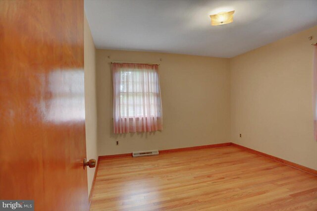 spare room featuring light hardwood / wood-style flooring