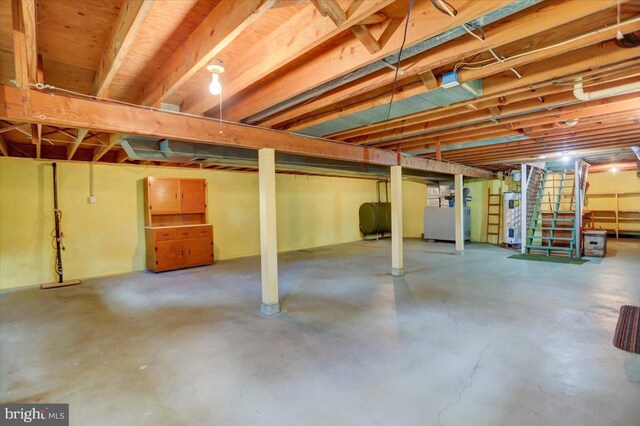 basement featuring heating unit and water heater