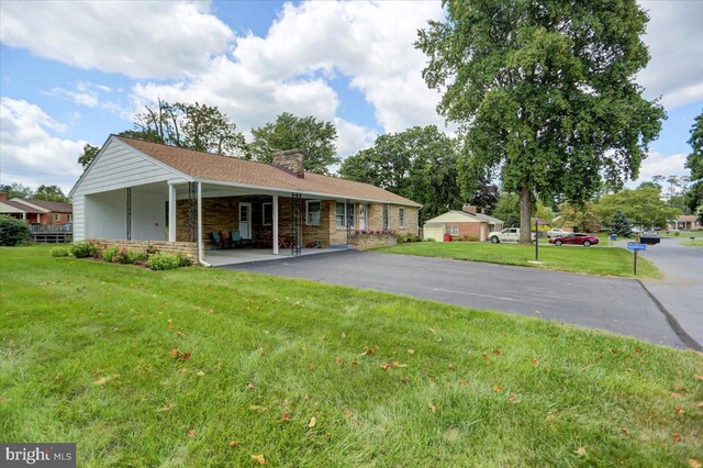 exterior space with covered porch and a yard