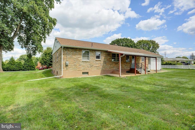 rear view of house featuring a patio area and a yard