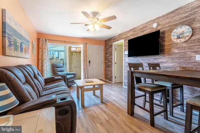 living room featuring ceiling fan and light hardwood / wood-style flooring