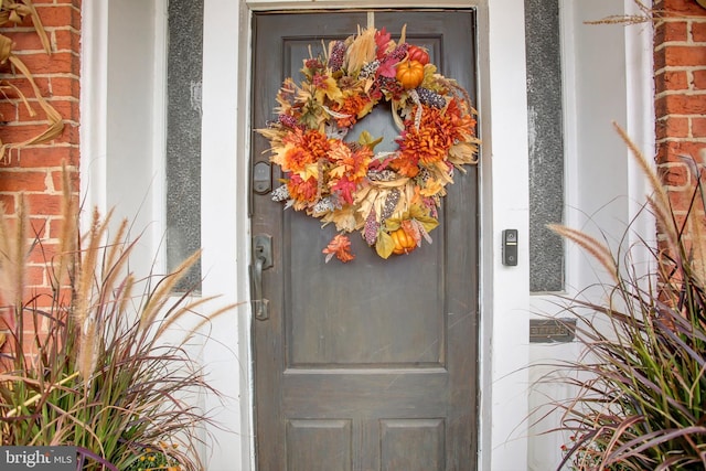 doorway to property with brick siding