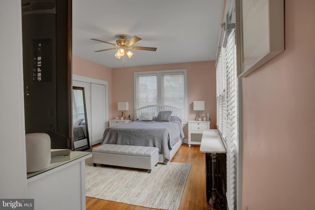 bedroom featuring a closet, ceiling fan, and light wood-style flooring