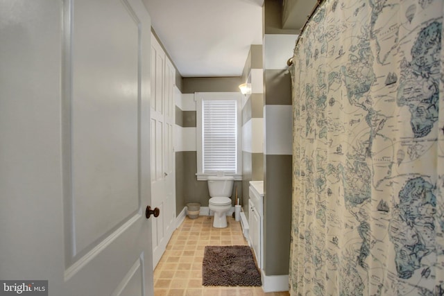 full bathroom with toilet, tile patterned floors, curtained shower, and vanity