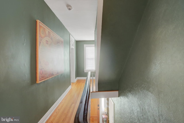 hall featuring baseboards and wood finished floors