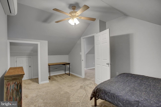 bedroom featuring a wall unit AC, vaulted ceiling, light carpet, and baseboards