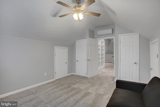 unfurnished living room featuring lofted ceiling, light carpet, a ceiling fan, baseboards, and an AC wall unit