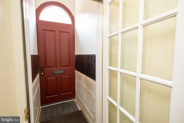 doorway to outside featuring dark tile patterned flooring