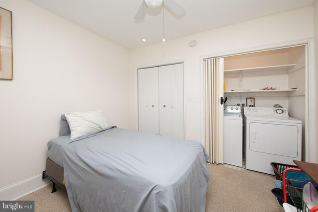 bedroom with light colored carpet, a closet, independent washer and dryer, and ceiling fan