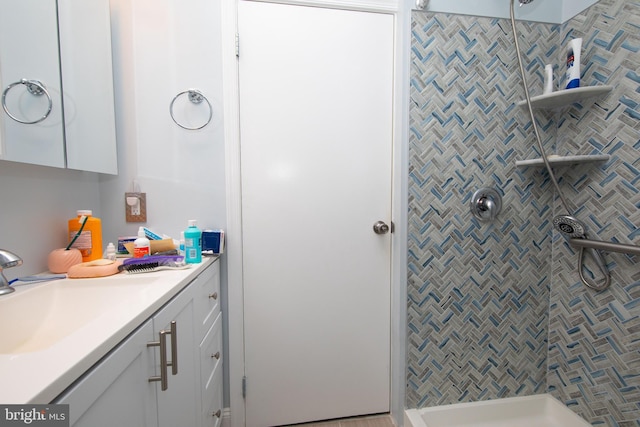 bathroom featuring sink and a tile shower