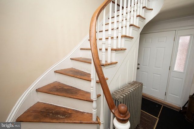 staircase featuring radiator heating unit and tile patterned flooring