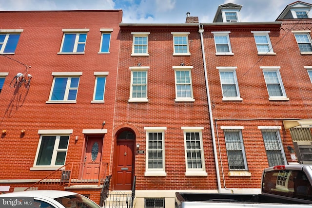 townhome / multi-family property featuring brick siding