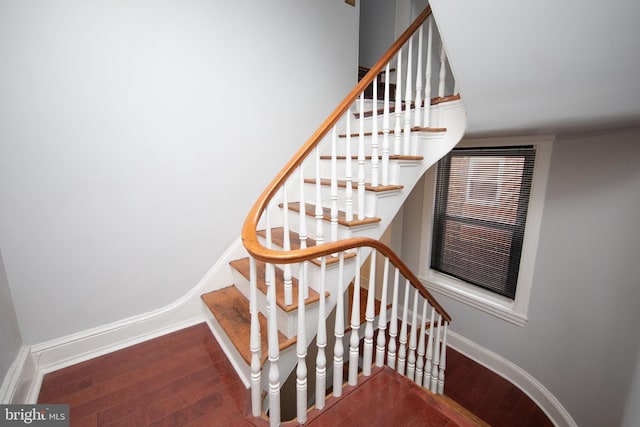 staircase with hardwood / wood-style flooring