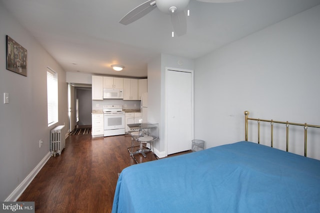 bedroom with radiator heating unit, ceiling fan, and dark hardwood / wood-style flooring