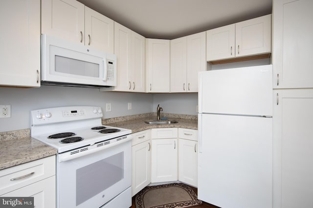 kitchen featuring sink, white cabinets, and white appliances