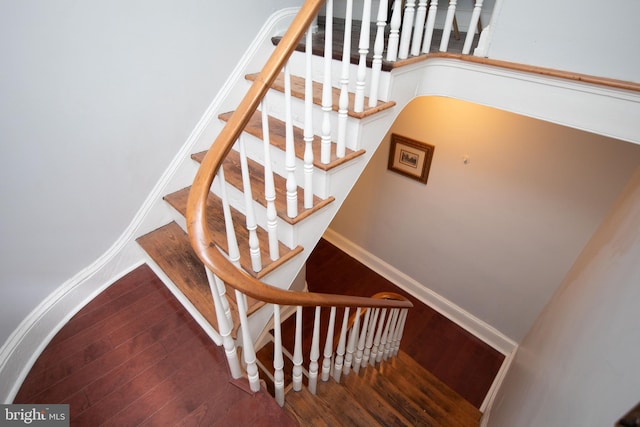 stairway featuring wood-type flooring