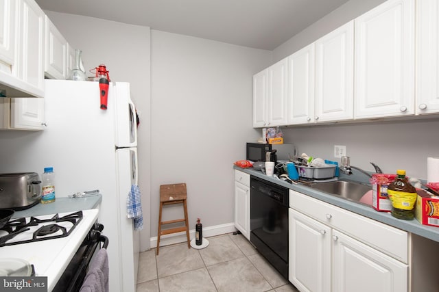 kitchen featuring white cabinetry, black dishwasher, light tile patterned floors, and white stove