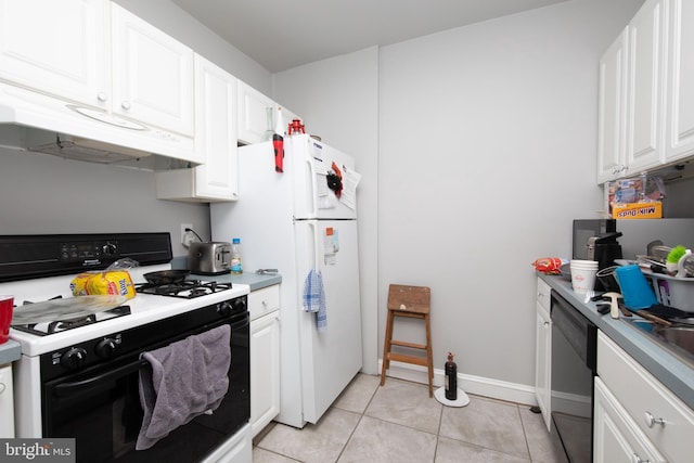 kitchen featuring white appliances, light tile patterned flooring, and white cabinetry