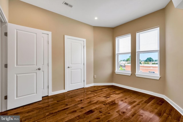 unfurnished bedroom with hardwood / wood-style flooring