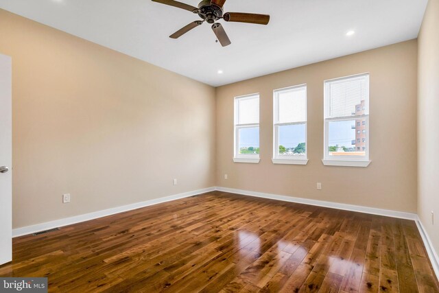 spare room with ceiling fan and hardwood / wood-style flooring