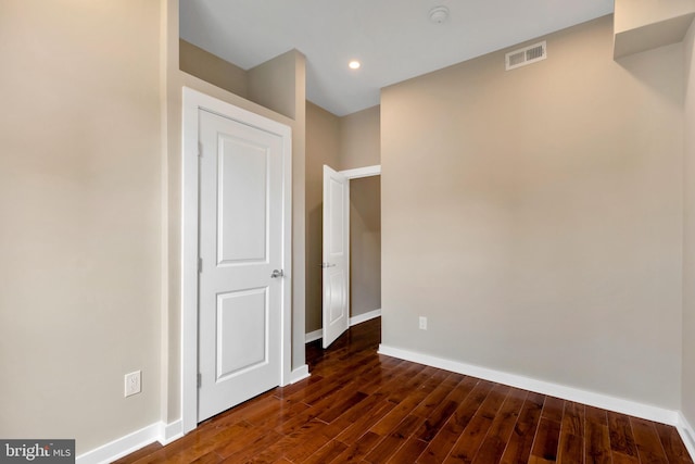 spare room with dark hardwood / wood-style floors