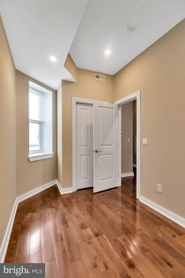 unfurnished bedroom with hardwood / wood-style flooring