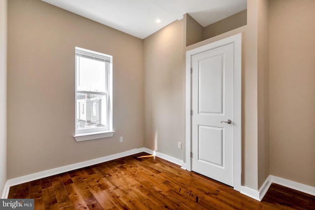 spare room featuring wood-type flooring